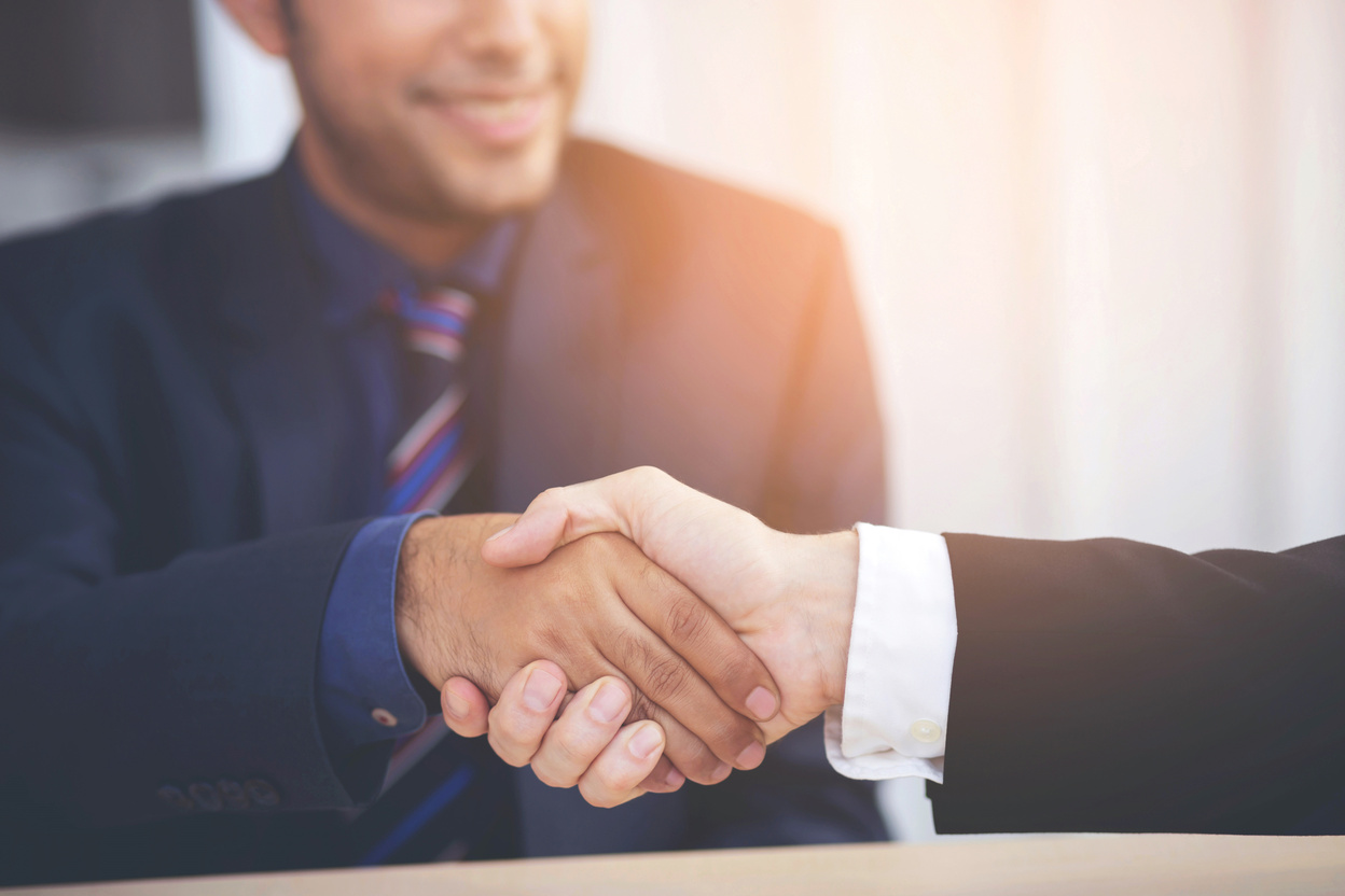 Business Professional Shake Hands to Do New Business Together